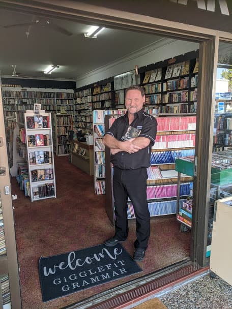 Darren, owner of Gigglefit Grammar, standing in the doorway of the shop